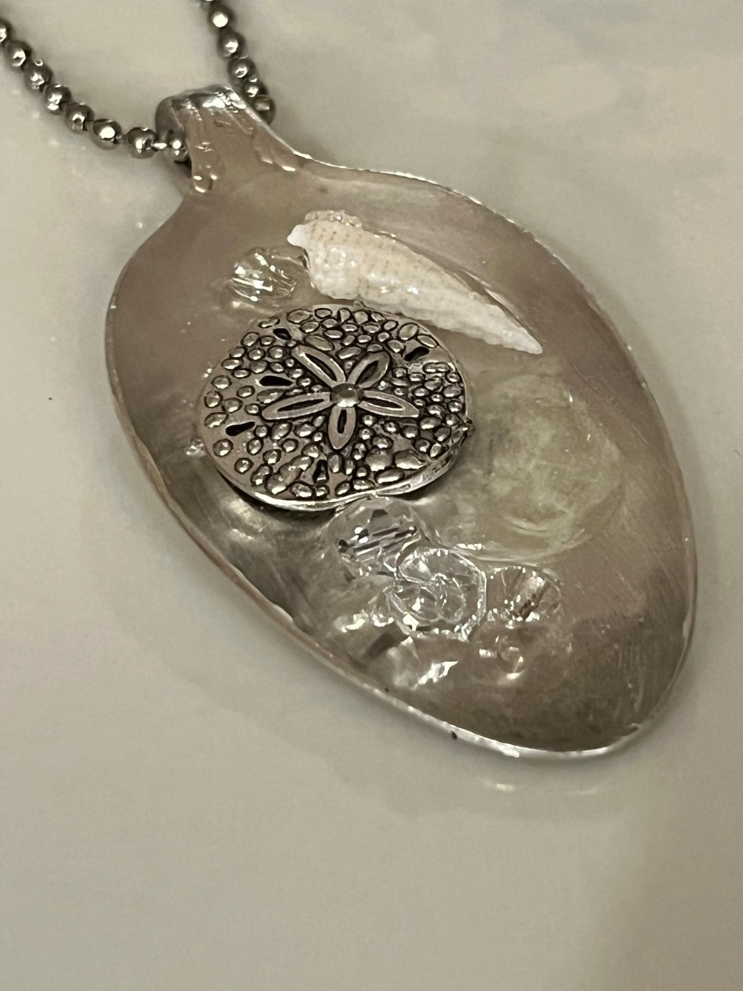 Silver sand dollar with shells Resin Pendant